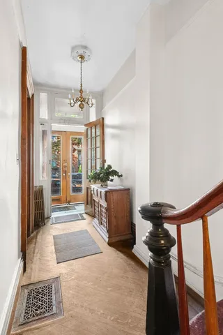 a view of a hallway with furniture and front door