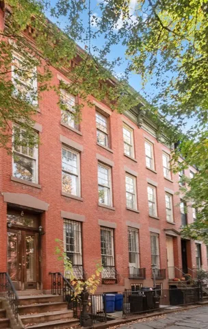 a bricked building with multiple trees