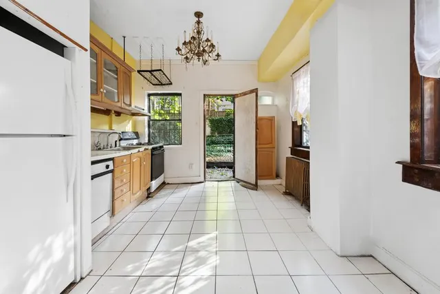 a view of kitchen with windows and refrigerator