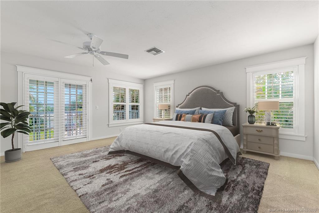 9 Middle Road Stuart, FL 34996 - Photo 16 of 32 a bedroom with a large bed and a large window