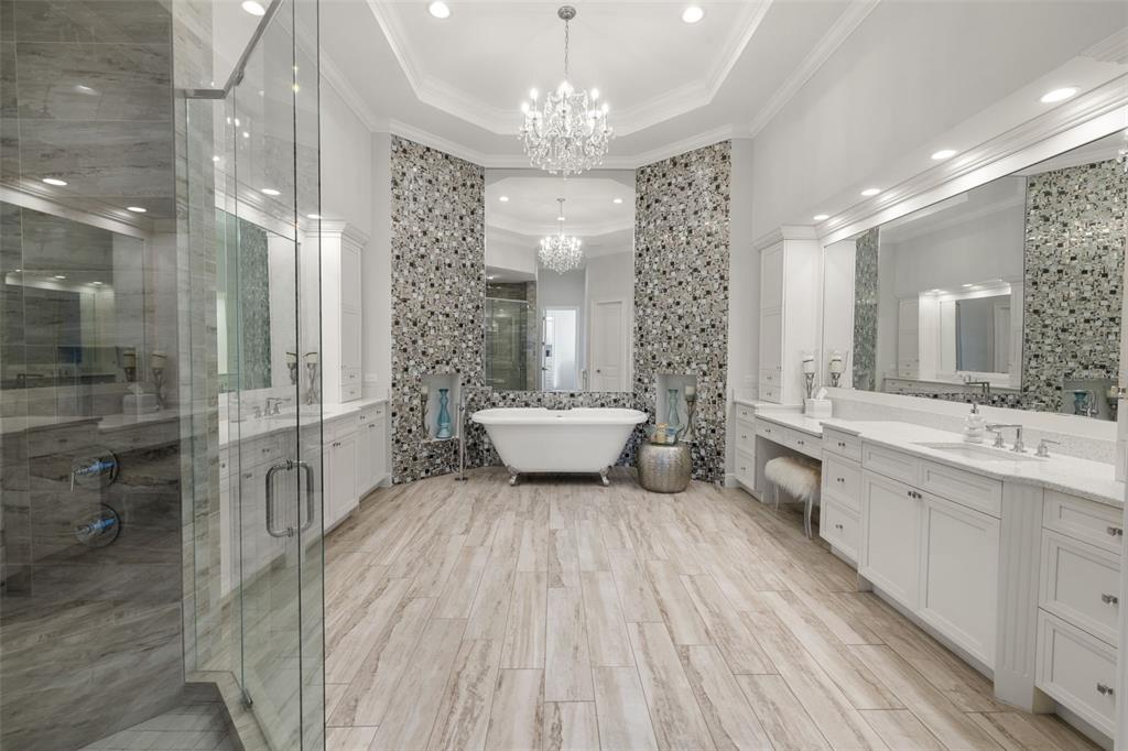 17124 Crawley Road Odessa, FL 33556 - Photo 54 of 98 a spacious bathroom with a double vanity sink a toilet a shower and a mirror