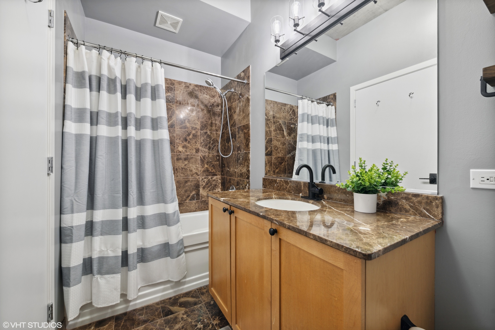 321 South Sangamon Street, Unit 810 Chicago, IL 60607 - Photo 13 of 14 a bathroom with a granite countertop sink a mirror and shower