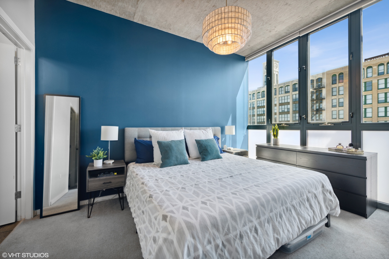 321 South Sangamon Street, Unit 810 Chicago, IL 60607 - Photo 9 of 14 a large bed sitting in a bedroom next to a large window