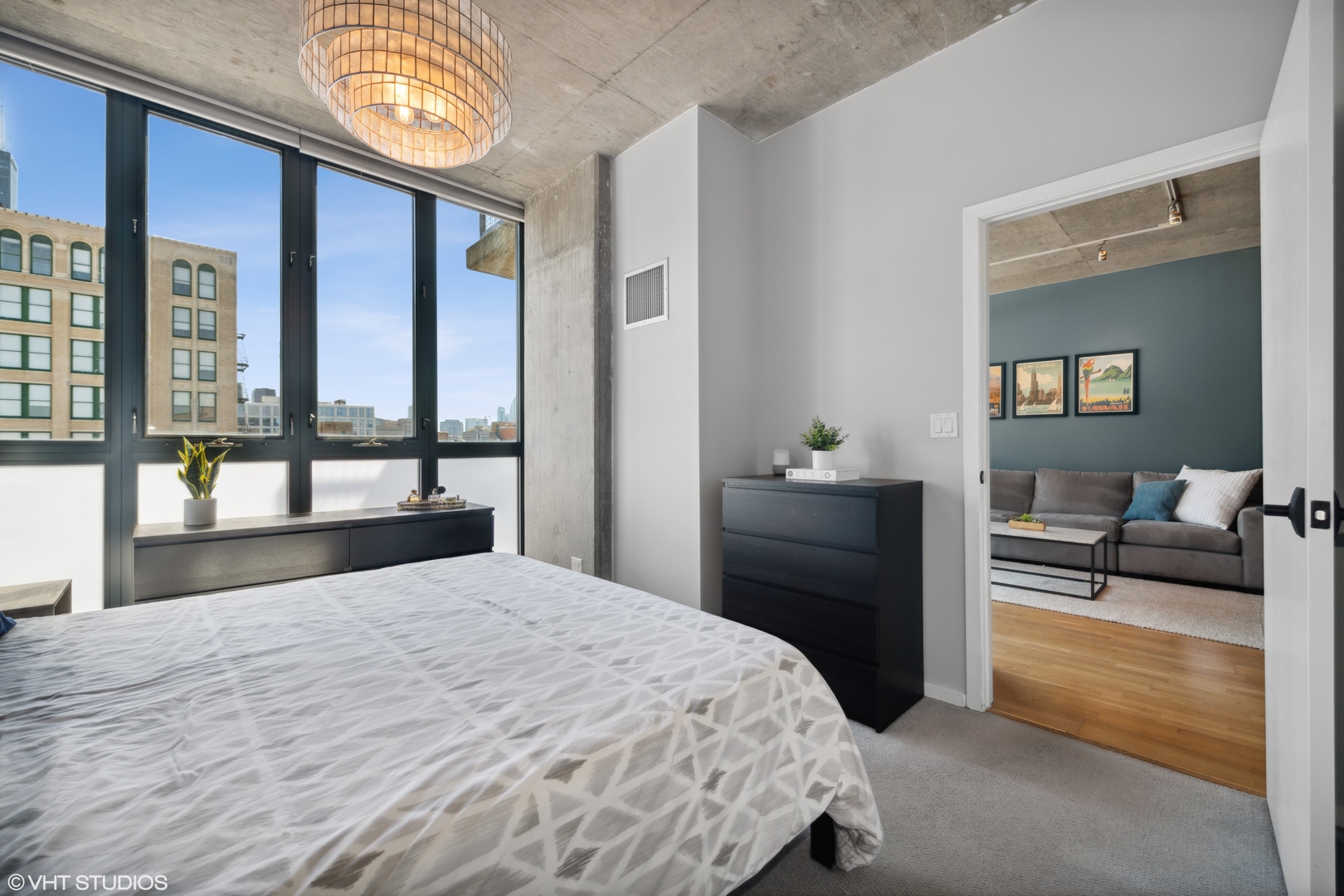 321 South Sangamon Street, Unit 810 Chicago, IL 60607 - Photo 10 of 14 a bedroom with a bed and a lamp on dresser