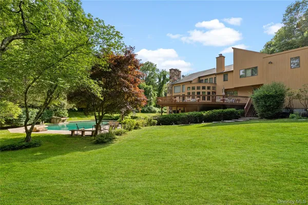 a view of a park with a house in the background