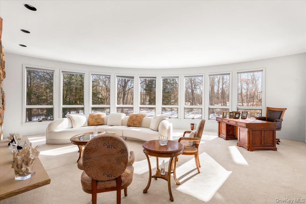 29 Captain Theale Road Bedford, NY 10506 - Photo 9 of 38 Carpeted living room featuring a desk and healthy amount of natural light