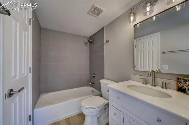 a bath room with a sink toilet and shower