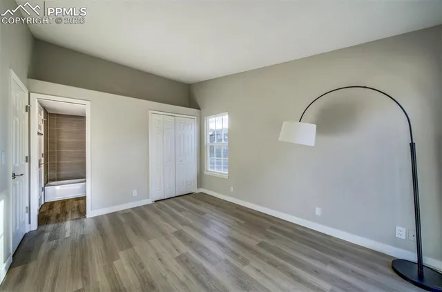 a view of a room with wooden floor