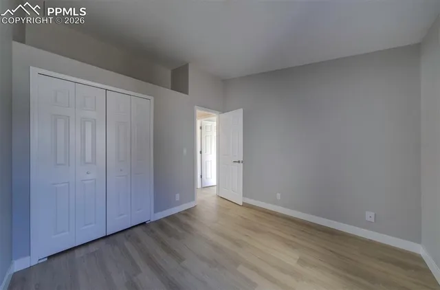 a view of an empty room and wooden floor