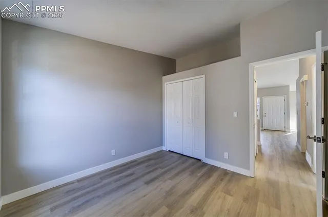a view of a room with wooden floor