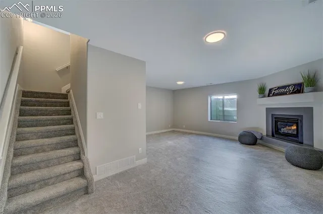 a view of a livingroom with fireplace and window