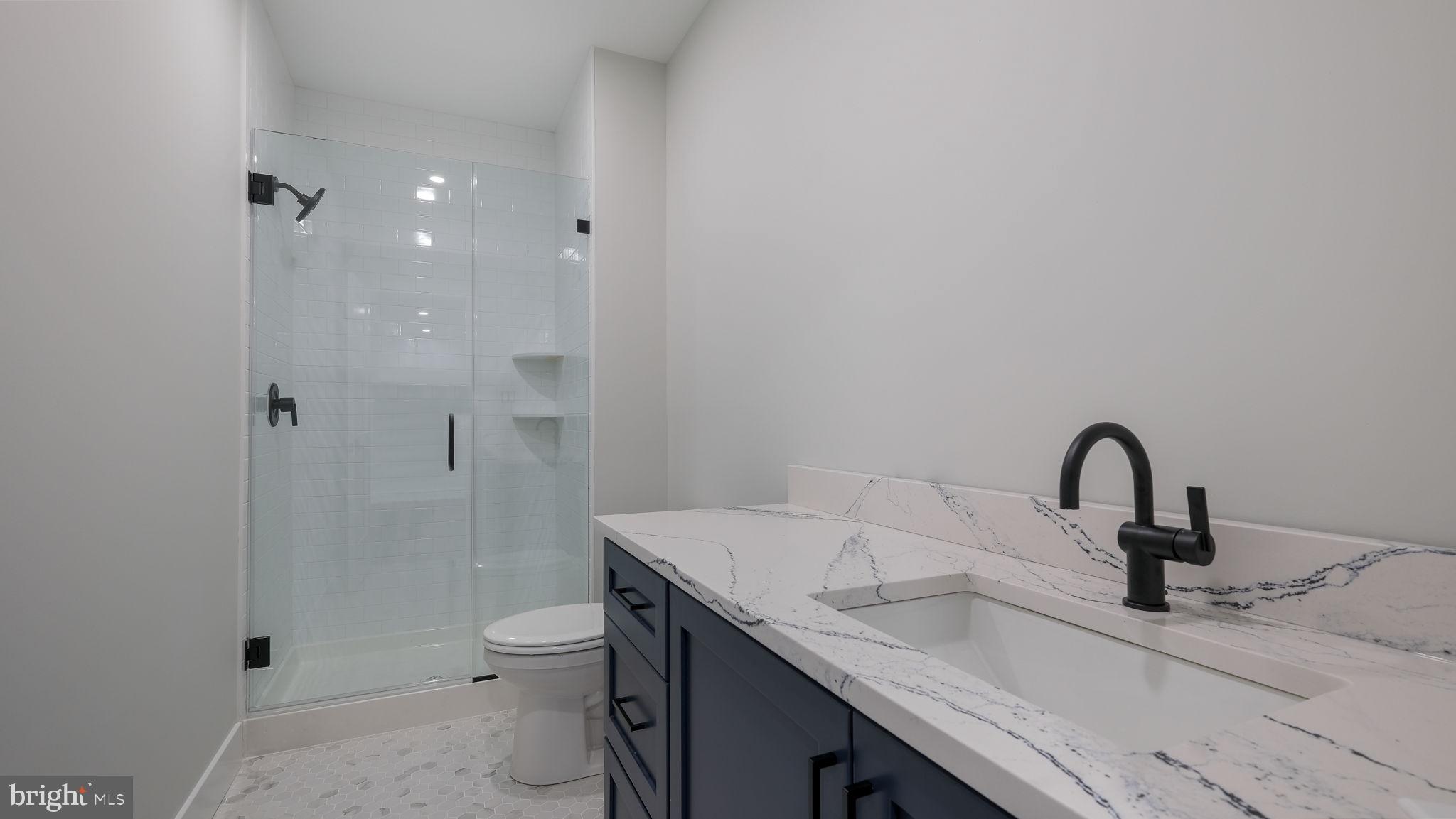 2550 Rickert Road Perkasie, PA 18944 - Photo 60 of 73 a bathroom with a granite countertop sink a toilet and shower