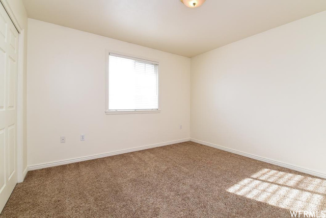 1130 North 200 West Bountiful, UT 84010 - Photo 8 of 11 Unfurnished bedroom with a closet and carpet floors
