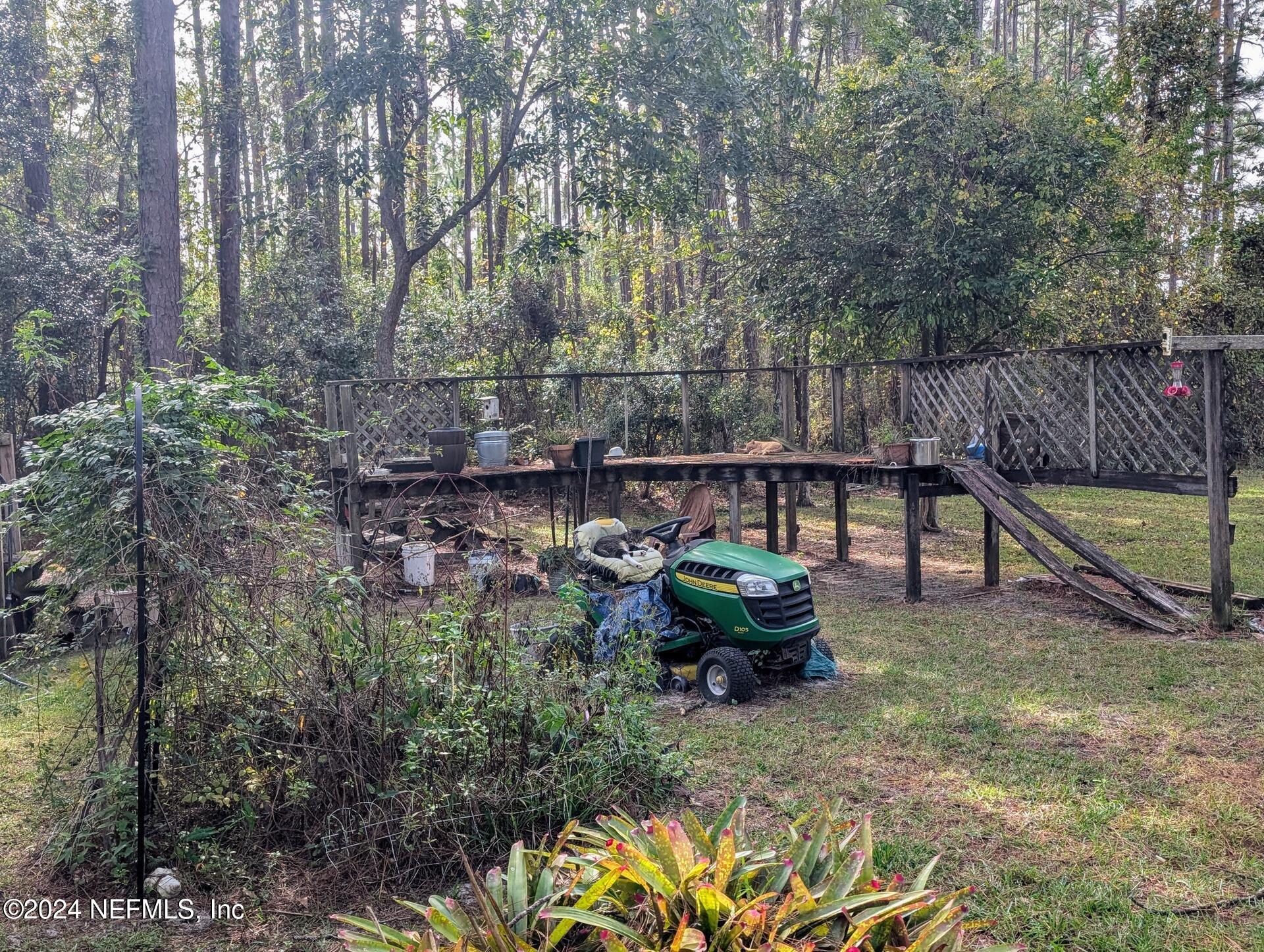 133 Mullis Avenue Interlachen, FL 32148 - Photo 3 of 45 Backyard Garden with Lawn Mower