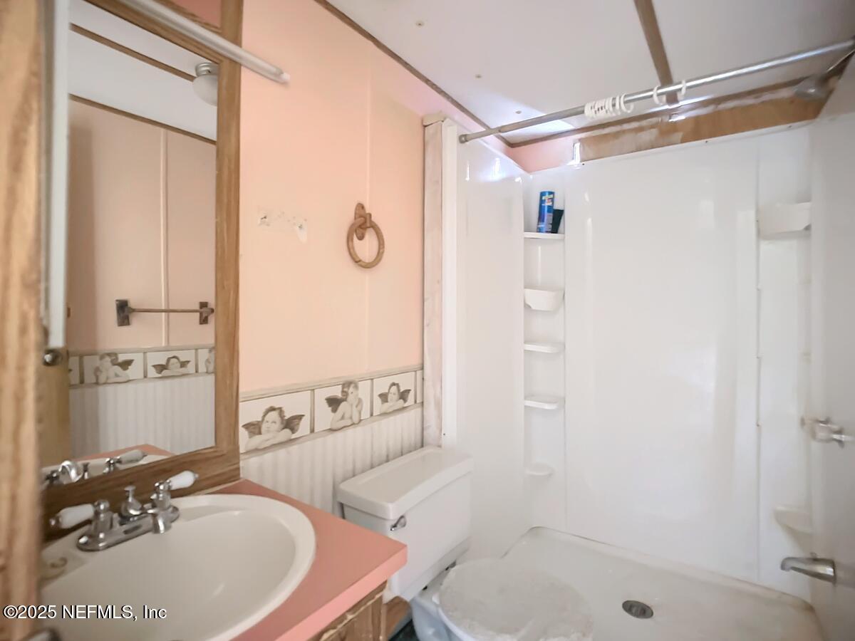 133 Mullis Avenue Interlachen, FL 32148 - Photo 43 of 45 Bathroom With Pink Countertop