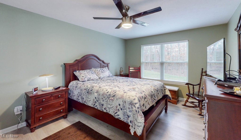 1005 Canyon View Road, Unit F Northfield, OH 44067 - Photo 13 of 28 Bedroom featuring ceiling fan and light hardwood / wood-style flooring