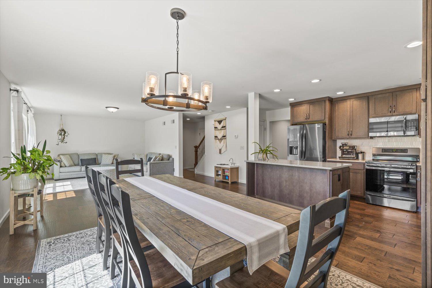 824 Hopeland Road Lititz, PA 17543 - Photo 11 of 46 a view of a dining room and livingroom with furniture wooden floor a chandelier