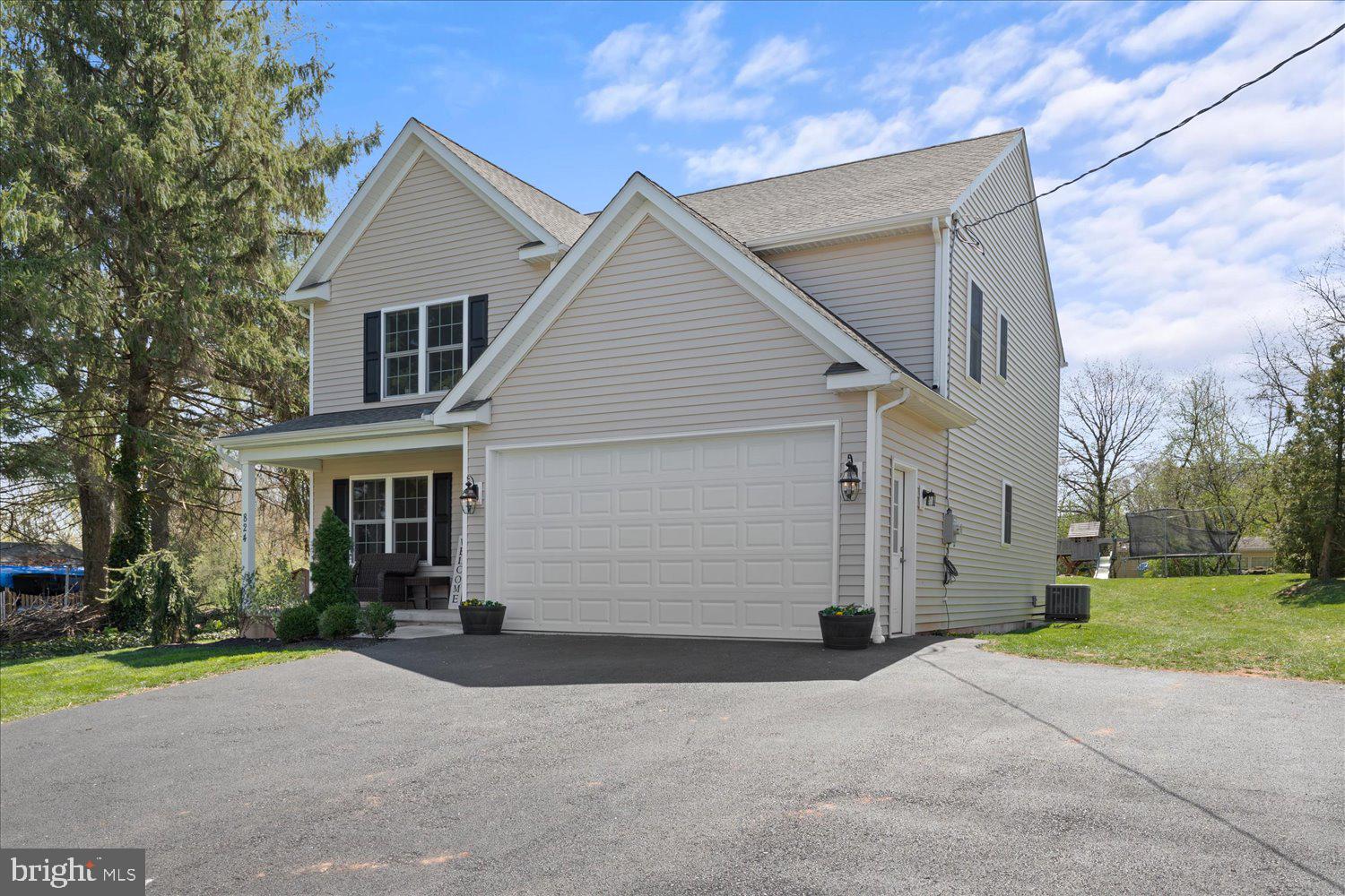 824 Hopeland Road Lititz, PA 17543 - Photo 2 of 46 a view of a white house with a yard and garage