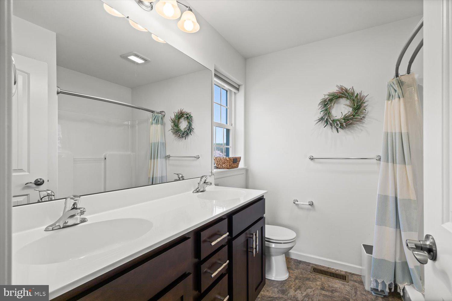 824 Hopeland Road Lititz, PA 17543 - Photo 21 of 46 a bathroom with a double vanity sink toilet and a mirror
