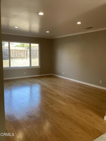 a kitchen with stainless steel appliances granite countertop a sink stove refrigerator and cabinets
