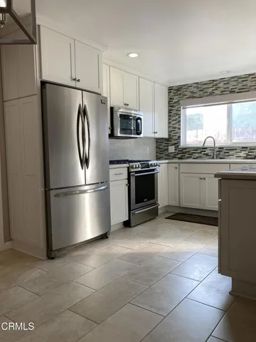 an empty room with wooden floor and a fireplace