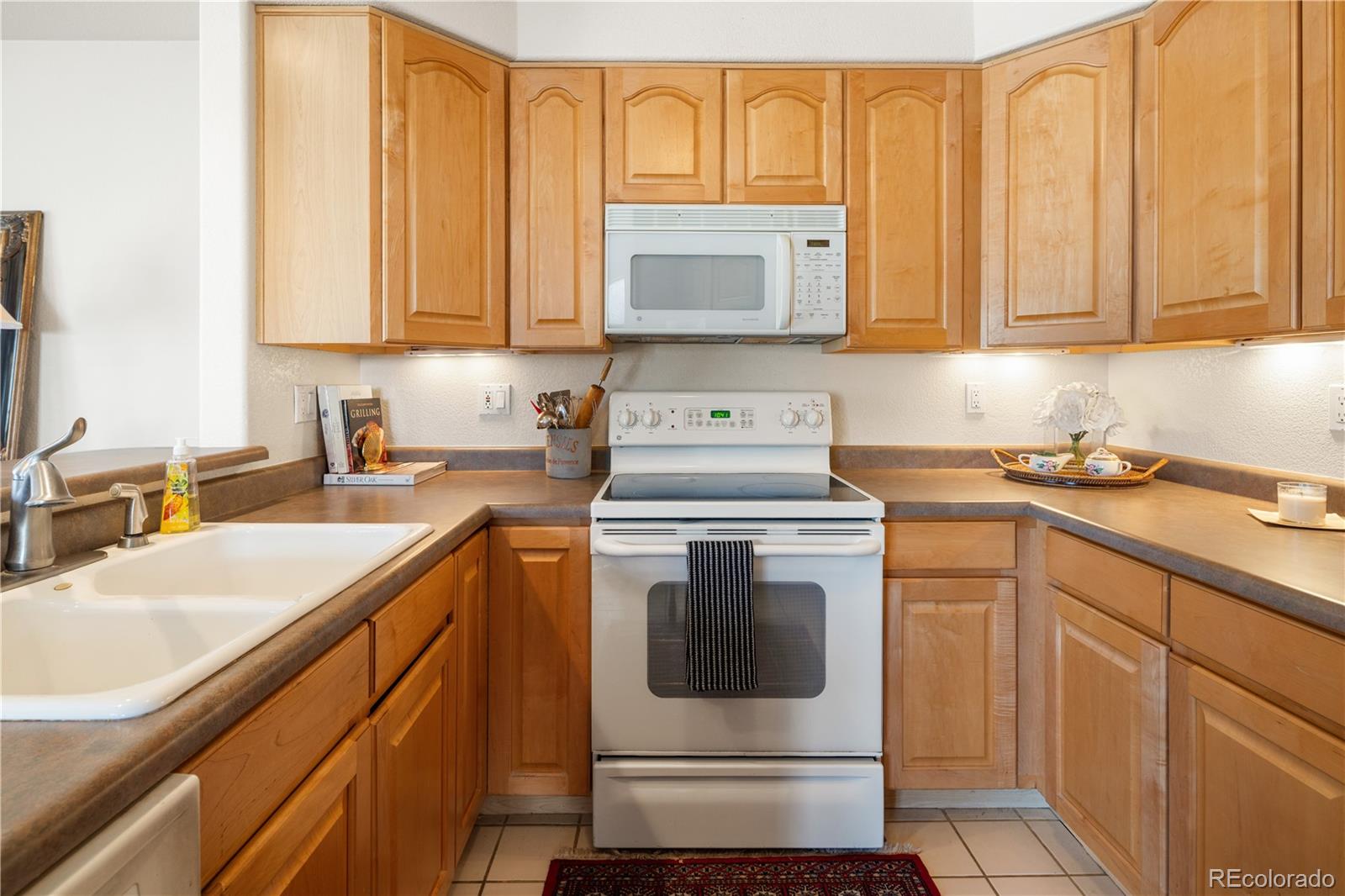 925 Hover Ridge Circle Longmont, CO 80501 - Photo 13 of 35 a kitchen with stainless steel appliances granite countertop a sink a stove and dishwasher with cabinets