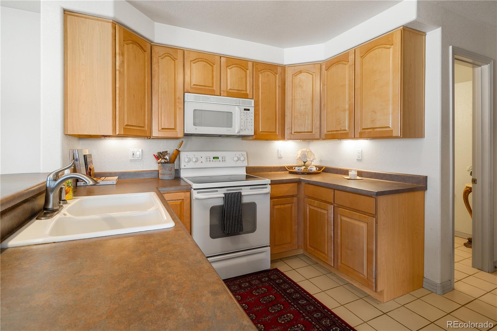 925 Hover Ridge Circle Longmont, CO 80501 - Photo 13 of 35 a kitchen with a sink cabinets and a window