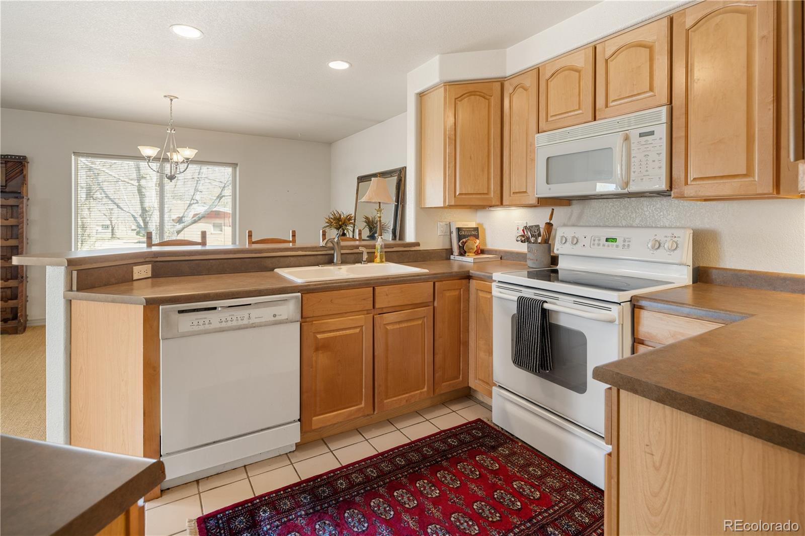 925 Hover Ridge Circle Longmont, CO 80501 - Photo 14 of 35 a kitchen with a sink stove and cabinets