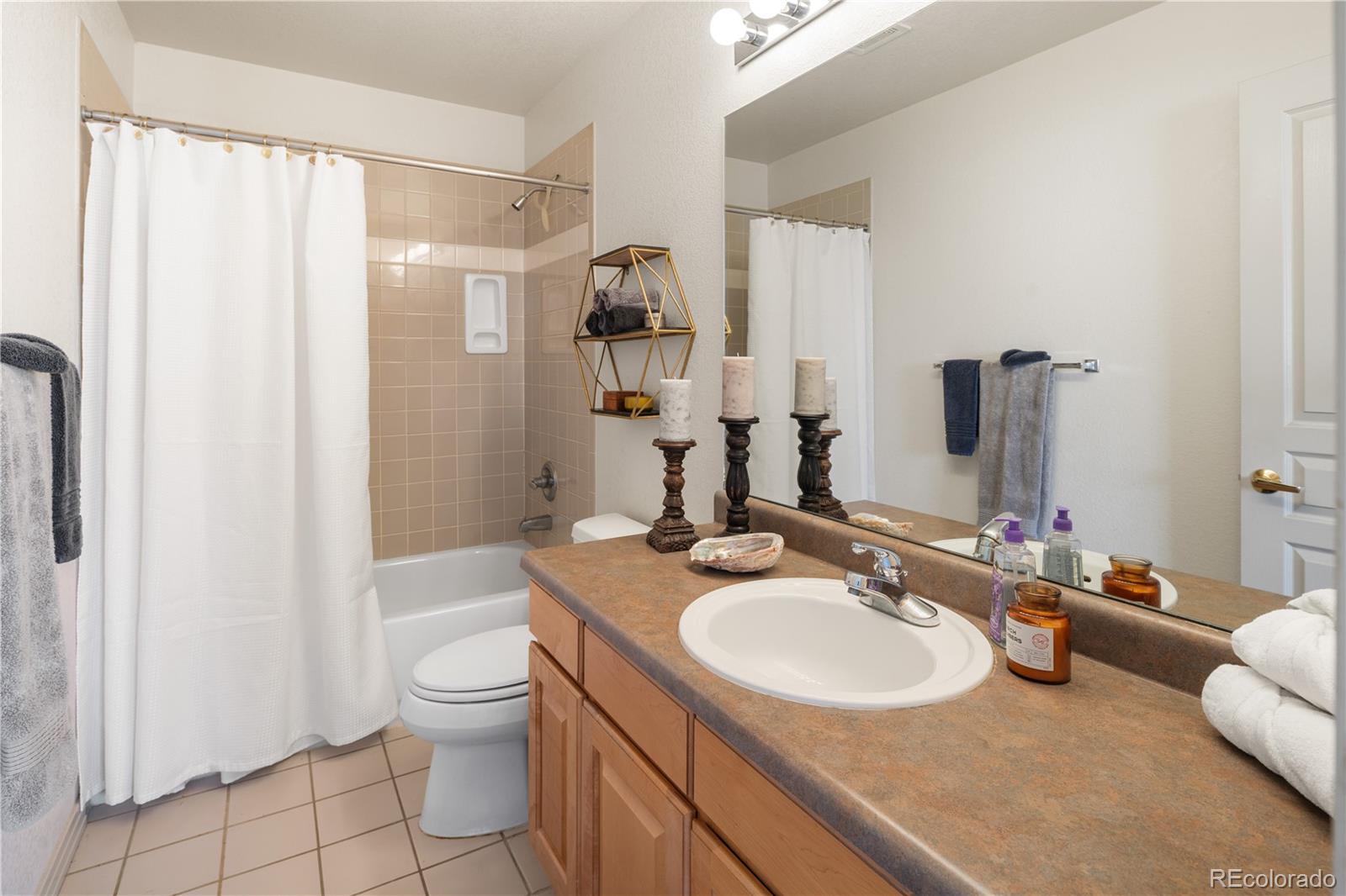 925 Hover Ridge Circle Longmont, CO 80501 - Photo 19 of 35 a bathroom with a sink toilet double vanity and tub