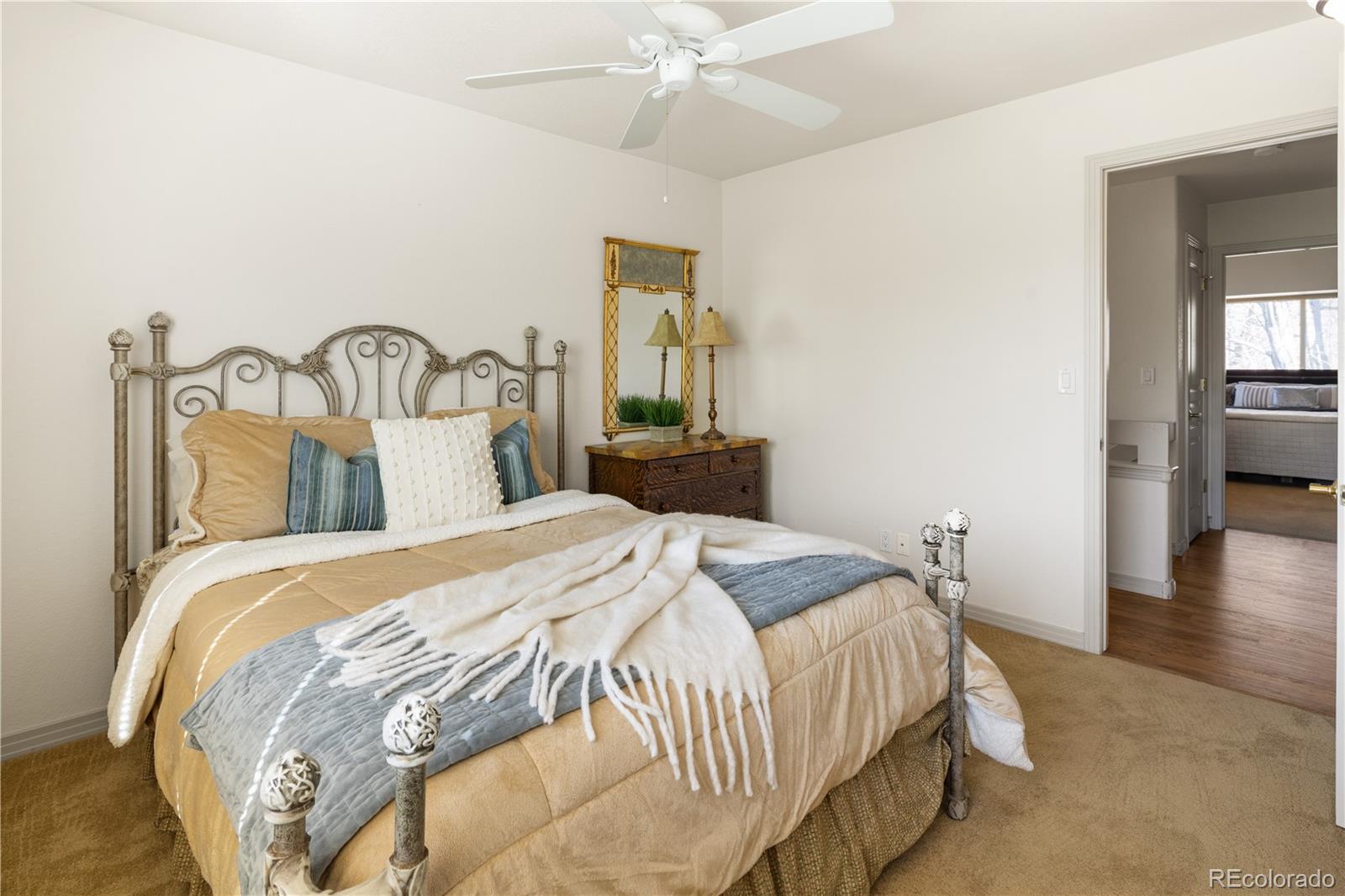 925 Hover Ridge Circle Longmont, CO 80501 - Photo 22 of 35 a bedroom with a bed and a chandelier