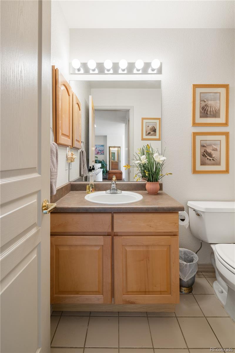 925 Hover Ridge Circle Longmont, CO 80501 - Photo 23 of 35 a bathroom with a toilet sink and mirror