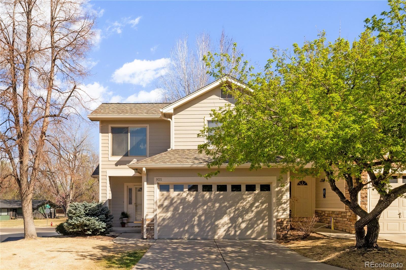 925 Hover Ridge Circle Longmont, CO 80501 - Photo 5 of 35 a front view of a house with a tree