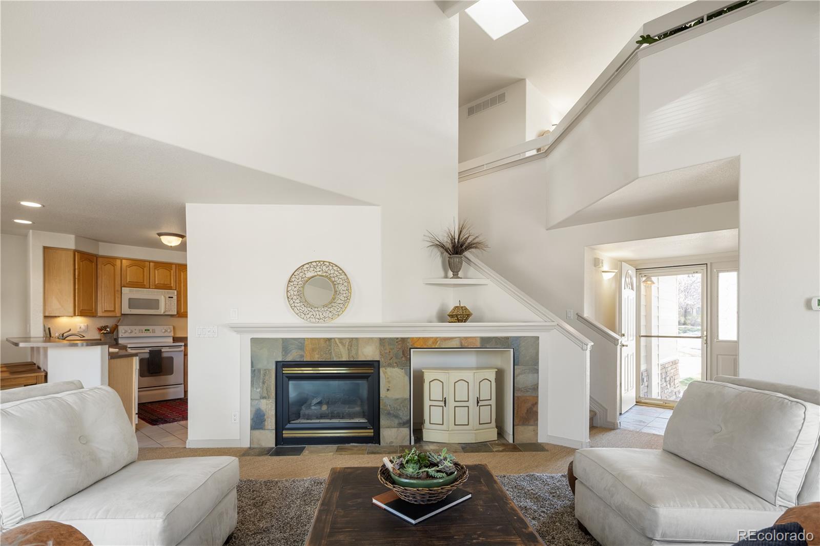 925 Hover Ridge Circle Longmont, CO 80501 - Photo 6 of 35 a living room with furniture and a fireplace