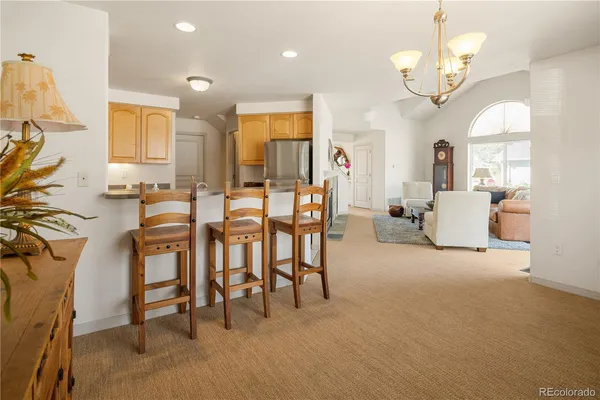 a view of a dining room with furniture and a chandelier