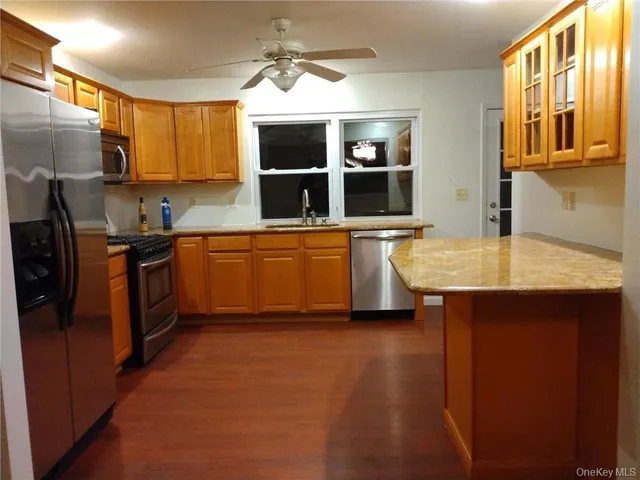 a kitchen with stainless steel appliances granite countertop a sink and a refrigerator