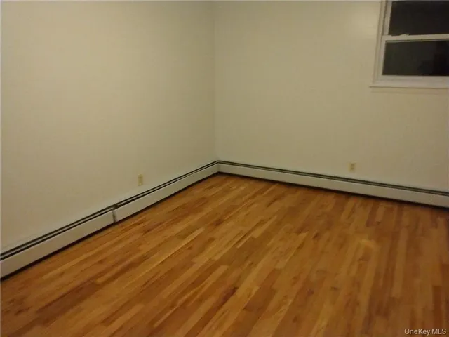 a view of a room with a wooden floor and a window