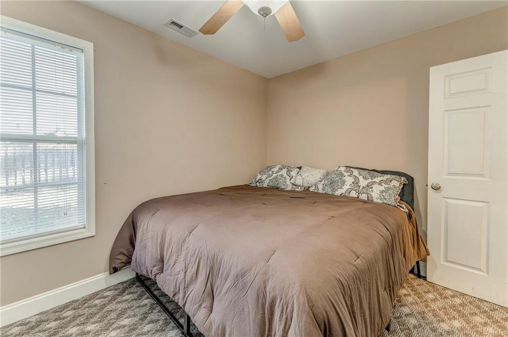 1040 Old Dalton Road Northeast Rome, GA 30165 - Photo 4 of 20 a large bed sitting in a bedroom next to a window