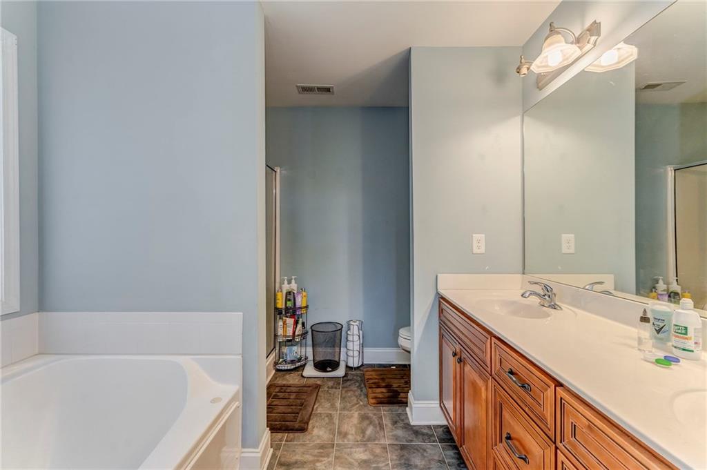1040 Old Dalton Road Northeast Rome, GA 30165 - Photo 8 of 20 a bathroom with a tub sink and mirror
