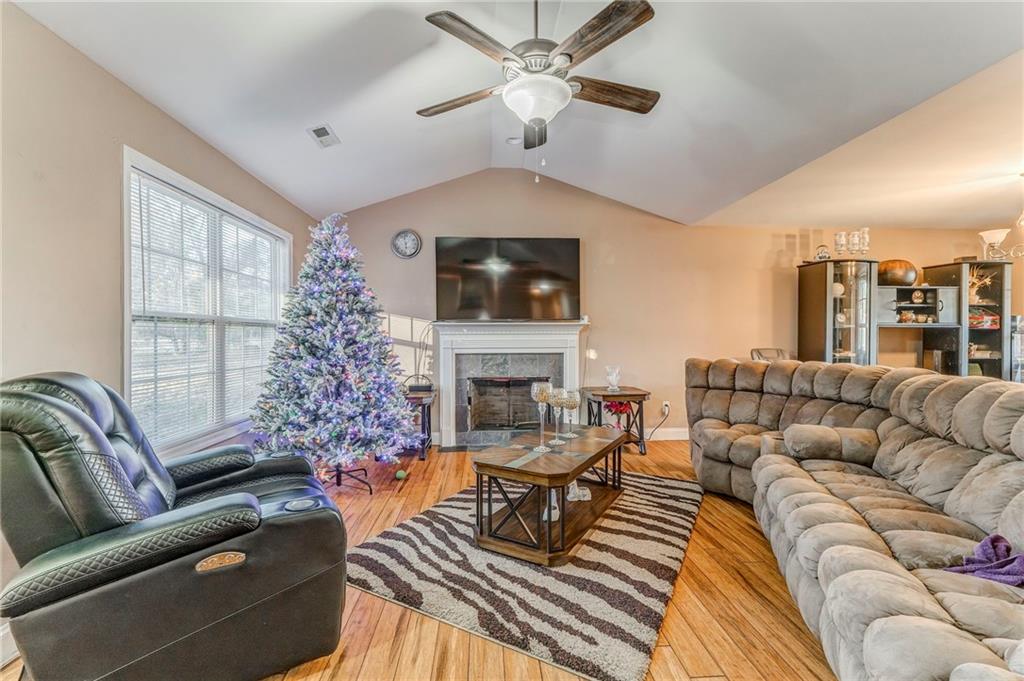 1040 Old Dalton Road Northeast Rome, GA 30165 - Photo 10 of 20 a living room with furniture a fireplace and a flat screen tv