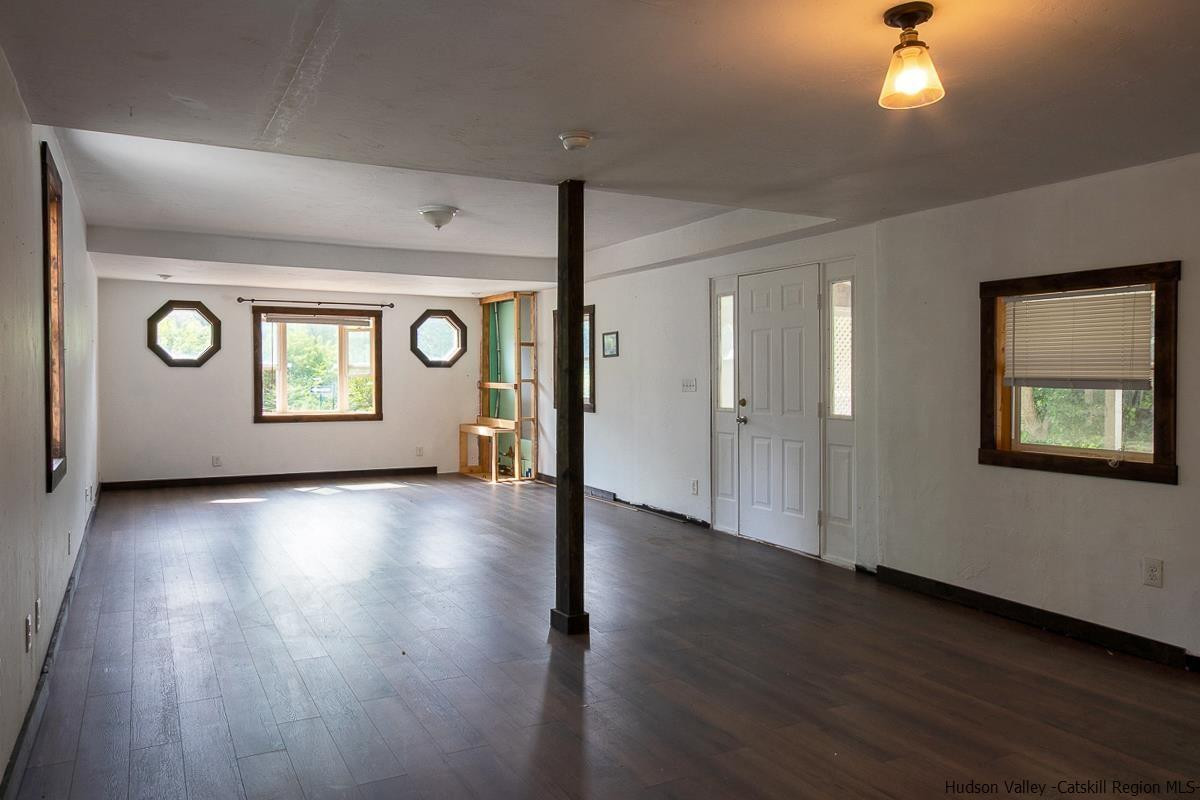 19 Dock Road Milton, NY 12547 - Photo 2 of 17 a view of an empty room with wooden floor and a window