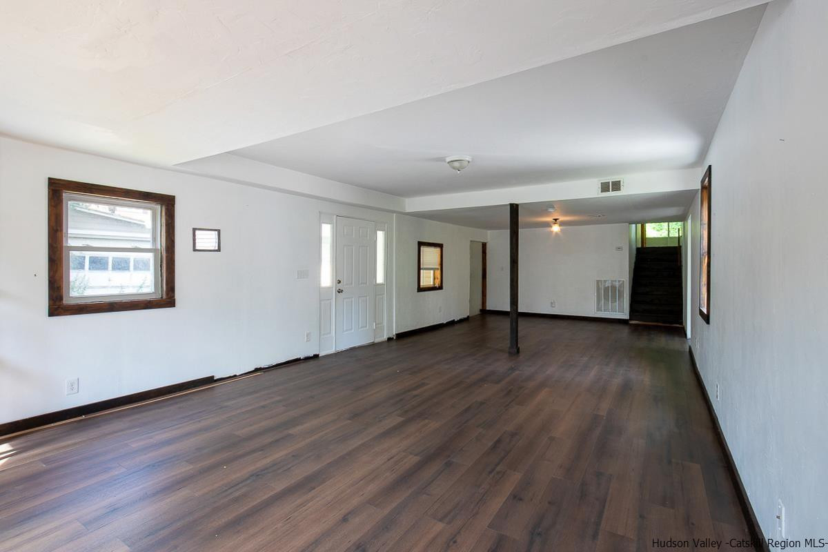 19 Dock Road Milton, NY 12547 - Photo 3 of 17 a view of a big room with wooden floor and windows