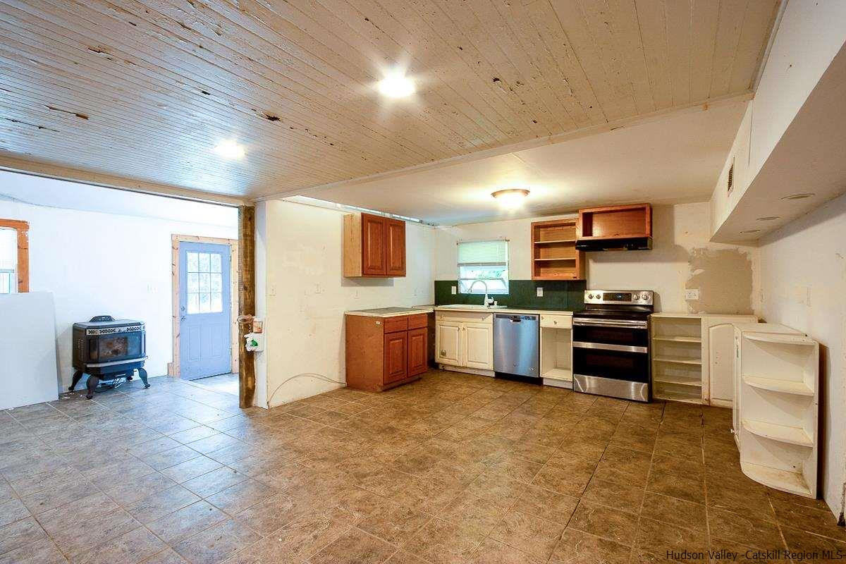 19 Dock Road Milton, NY 12547 - Photo 4 of 17 a kitchen with stainless steel appliances kitchen island granite countertop a stove and a refrigerator