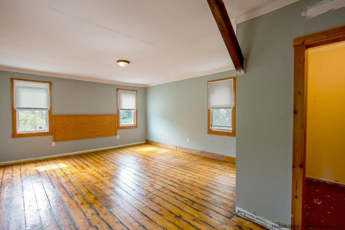 19 Dock Road Milton, NY 12547 - Photo 5 of 17 a view of empty room with wooden floor and fan