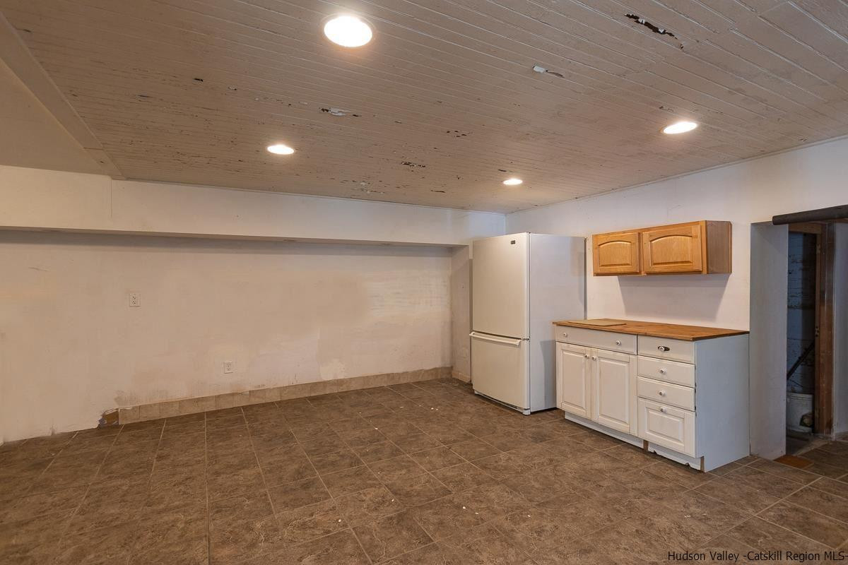 19 Dock Road Milton, NY 12547 - Photo 7 of 17 a kitchen with granite countertop white cabinets and stainless steel appliances