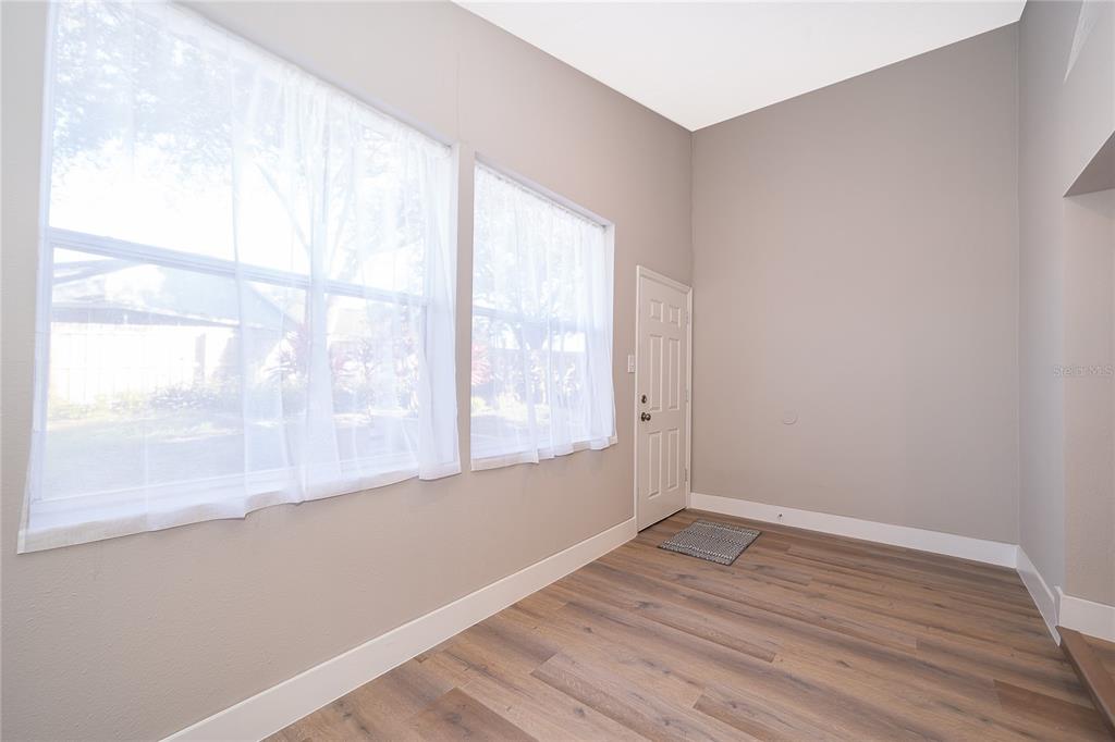 1652 Riveredge Road Oviedo, FL 32766 - Photo 11 of 22 a view of empty room with wooden floor and fan