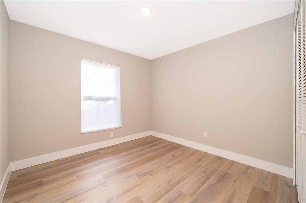 1652 Riveredge Road Oviedo, FL 32766 - Photo 14 of 22 an empty room with wooden floor and windows