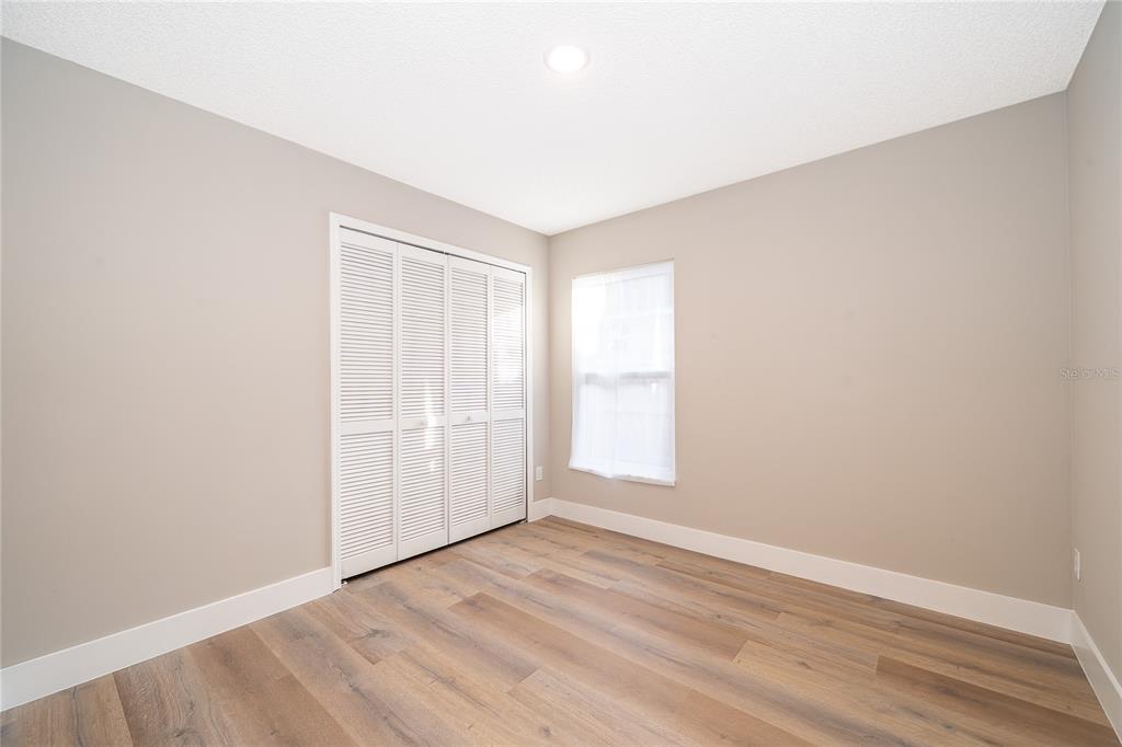 1652 Riveredge Road Oviedo, FL 32766 - Photo 15 of 22 an empty room with wooden floor and windows