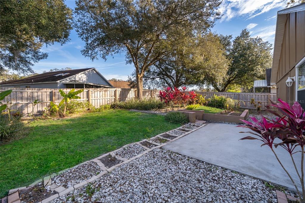 1652 Riveredge Road Oviedo, FL 32766 - Photo 21 of 22 a view of a house with a yard and garden