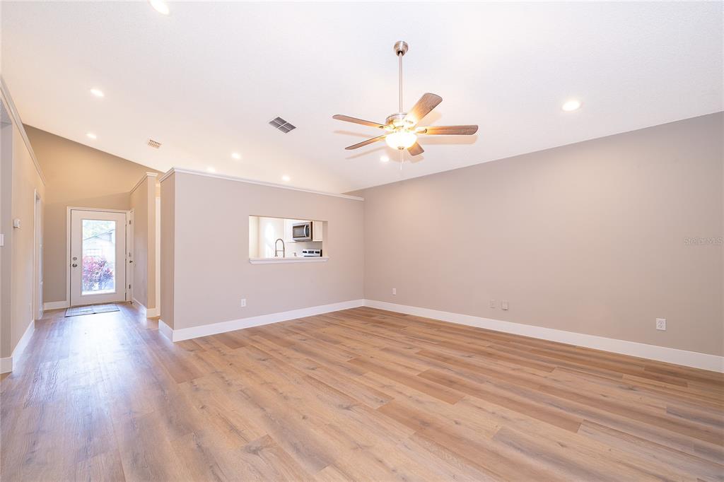 1652 Riveredge Road Oviedo, FL 32766 - Photo 3 of 22 wooden floor in an empty room with a window