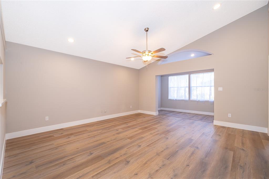 1652 Riveredge Road Oviedo, FL 32766 - Photo 4 of 22 a view of an empty room with wooden floor and a window